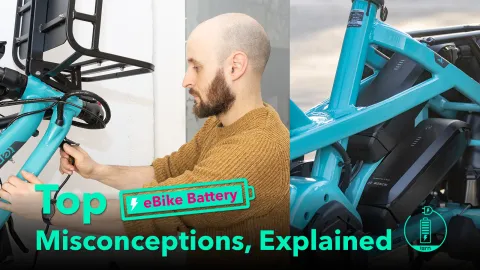 Banner image for article on top eBike battery misconceptions, showing man plugging in an e-bike for charging